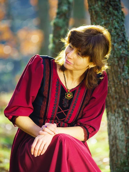 Woman in red dress portrait, autumnal forest — Stock Photo, Image