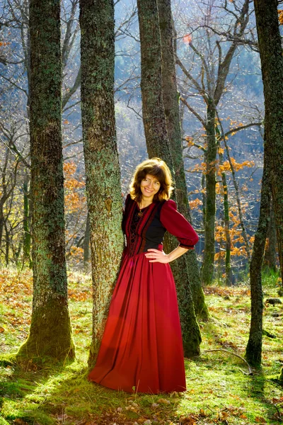 Woman in red dress portrait, autumnal forest — Stock Photo, Image