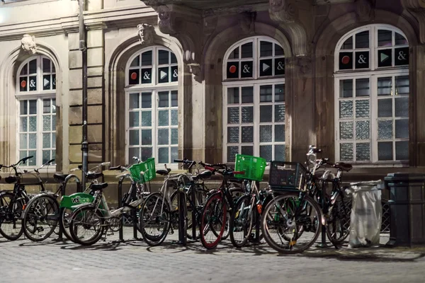Bycicles waiting for owners at night street — Stock Photo, Image