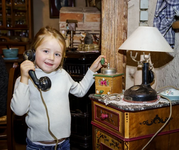 Cute preschooler girl talking by old vintage retro telephon — Stock Photo, Image