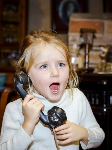 Cute preschooler girl talking by old vintage retro telephon — Stock Photo, Image