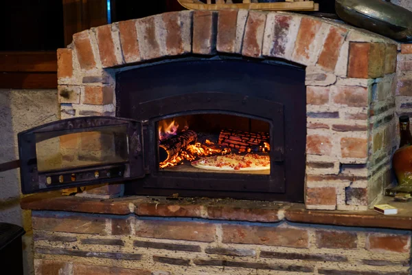 Pizza cooking in natural vintage stove — Stock Photo, Image