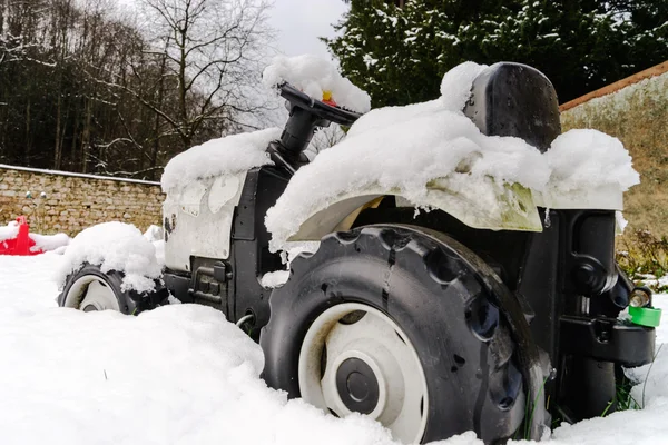 Children toy tractor over the snow — Stock Photo, Image
