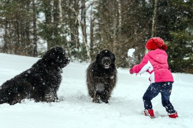 Children playing with big water-dog in snow clipart