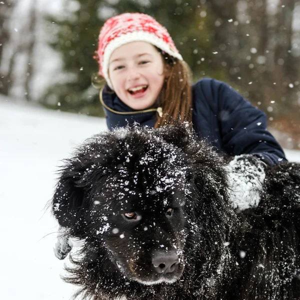 Children playing with big water-dog in snow — Stock Photo, Image