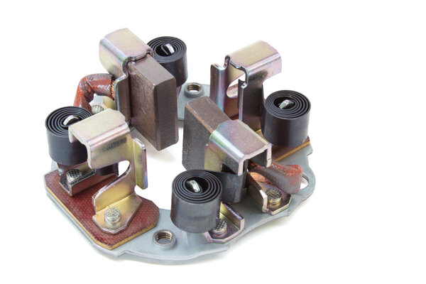 Щётки генератора. запчасти для стартера к автомобилю на белом фоне
