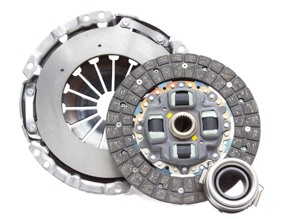 A new set of replacement automotive clutch on a white. Disc and clutch basket with release bearing — Φωτογραφία Αρχείου