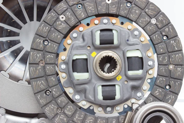 A new set of replacement automotive clutch on a white. Disc and clutch basket with release bearing — 图库照片