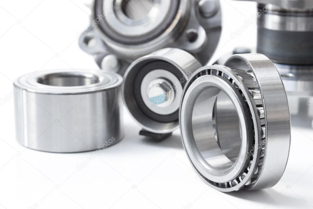 various bearings lie on a gray