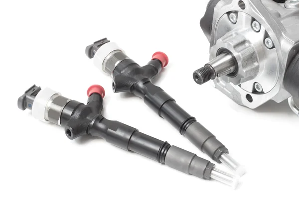 New solenoid injectors for diesel fuel lying on a white background with a rod and a fuel injection pump — Stock Photo, Image