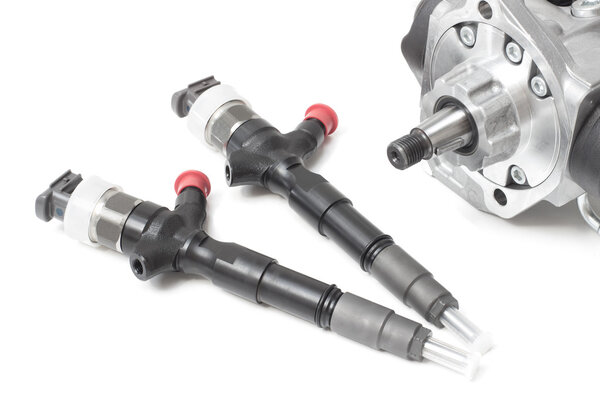 new solenoid injectors for diesel fuel lying on a white background with a rod and a fuel injection pump