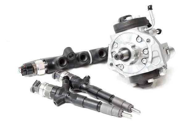 New solenoid injectors for diesel fuel lying on a white background with a rod and a fuel injection pump — Stock Photo, Image