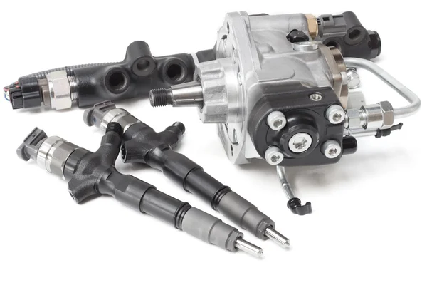 New solenoid injectors for diesel fuel lying on a white background with a rod and a fuel injection pump — Stock Photo, Image