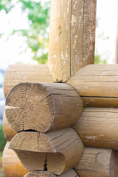 Beginning of rural house construction from heavy logs against blue sky with white clouds in summer day — Stock Photo, Image