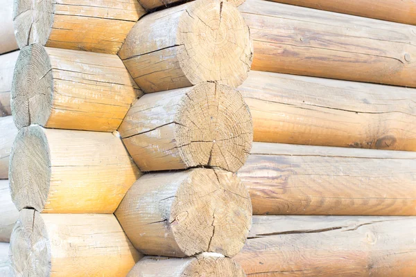 Beginning of rural house construction from heavy logs against blue sky with white clouds in summer day — Stock Photo, Image