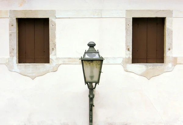 Lantern between two windows — Stock Photo, Image