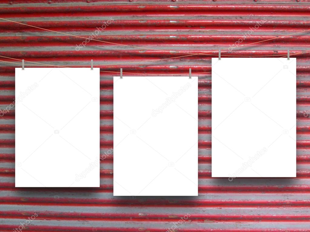 Three hanged vertical paper sheets on red shutter