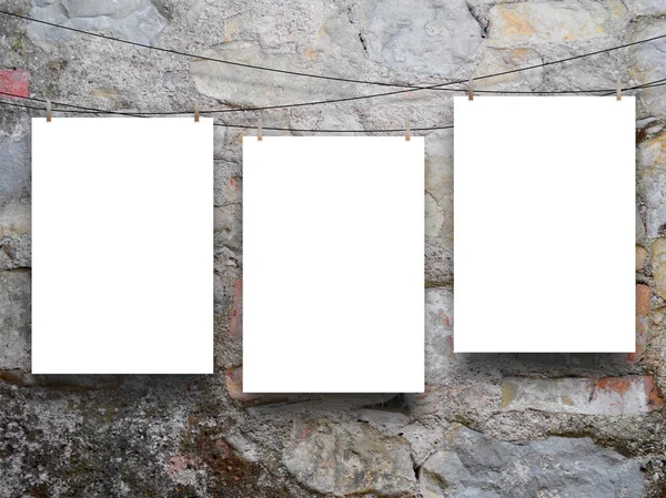 Three hanged sheets on ancient wall — Stock Photo, Image
