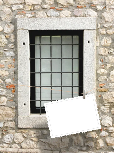 Single hanged postcard on medieval window — Stock Photo, Image