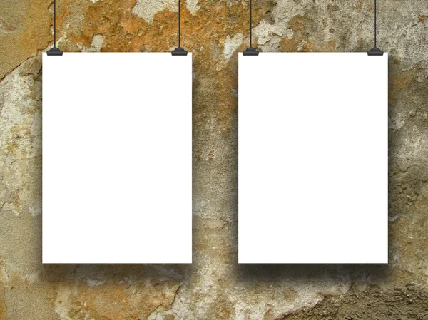 Two hanged paper sheets on yellow grungy concrete wall — Stock Photo, Image