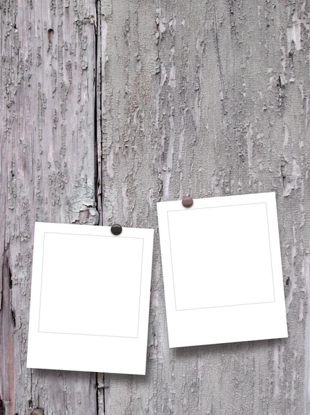 Two blank square instant photo frames with pins on grungy scratched wooden boards — Stock Photo, Image