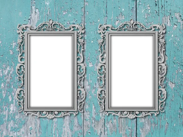 Two silver baroque frames on blue scratched wooden boards — Stock Photo, Image