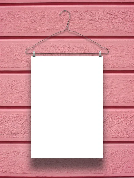Single hanged rectangular paper sheet with hanger on red concrete wall — Stock Photo, Image