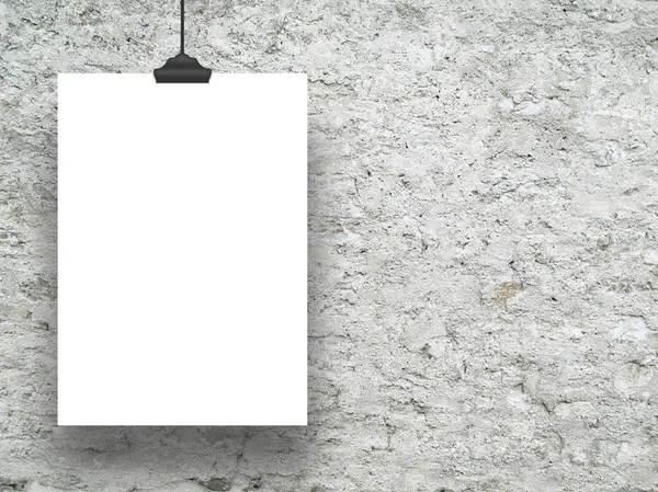 Single hanged vertical paper sheet on the left with clip on rough concrete wall — Stock Photo, Image