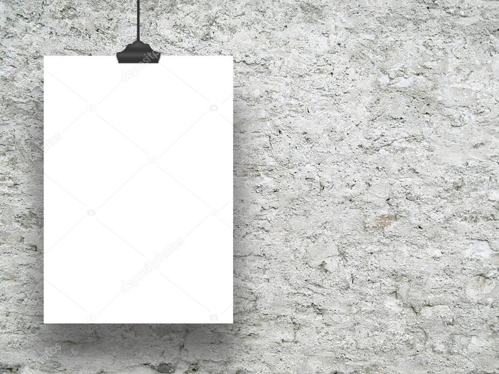 Single hanged vertical paper sheet on the left with clip on rough concrete wall