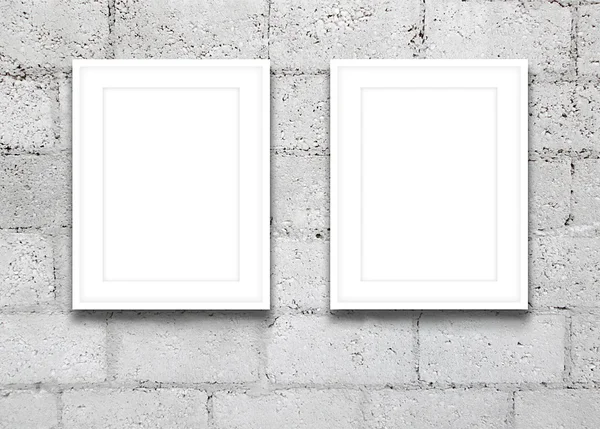 Close-up de duas molduras brancas na parede de blocos de concreto cinza — Fotografia de Stock