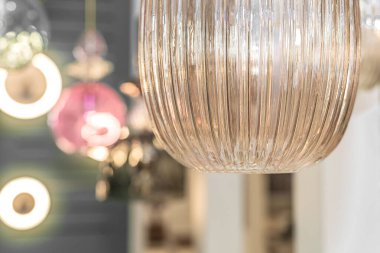 Tavandan kahverengi camdan yapılmış kapalı bir tavan avizesi asılıdır. İç mekan dekorasyonu kavramı. İçeri gir. Kapat..