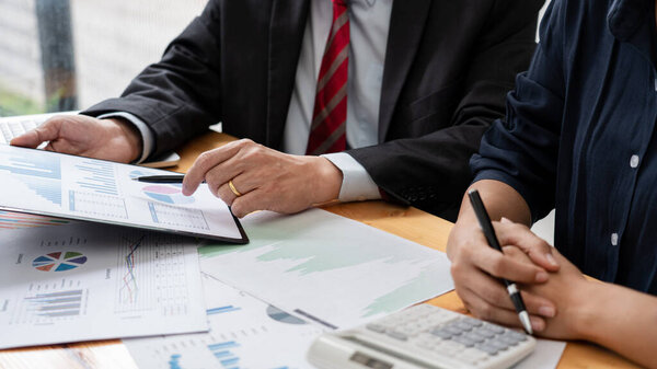 business professionals sitting around table meeting colleagues working together brainstorming on project discussing and planning concept at office.