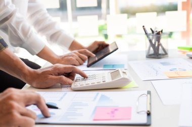 İş adamı finans müfettişi ve sekreteri rapor hazırlıyor ve iş arkadaşıyla birlikte modern bir çalışma alanında beyin fırtınası yapıyorlar..