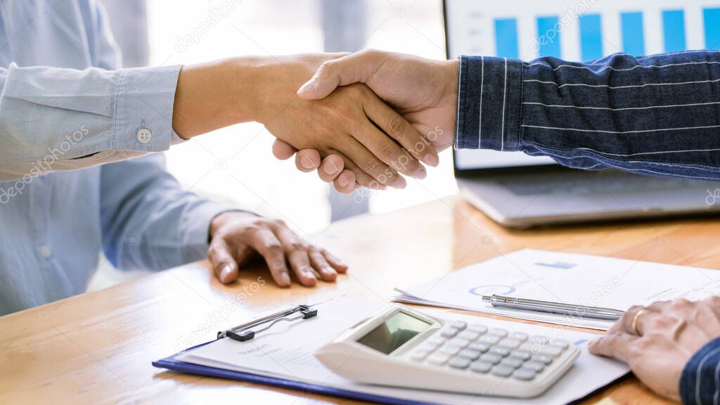 handshaking of agreement to make a contract starting new financial business.