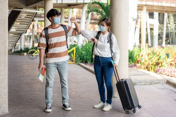 Travel, man and woman act team pose during trip. stand and look at each other. carry luggage and backpacks.stripped shirt and eyeglasses.