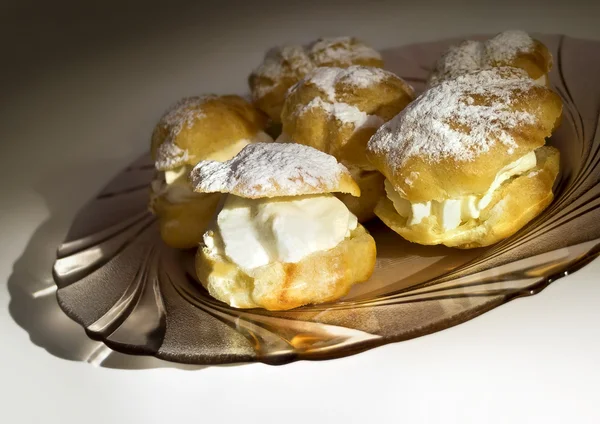 Cream puff with filling on a plate — Stock Photo, Image