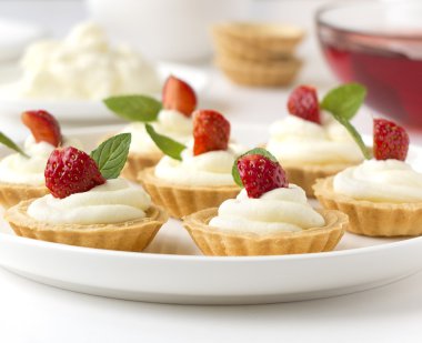 Birçok kek, taze meyve (çilek), ile cupcakes çırpılmış krema, jöle ve nane şekeri