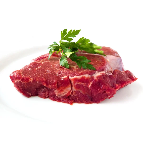 Beef fillet steak with sprig of parsley on white background, isolated — Stock Photo, Image