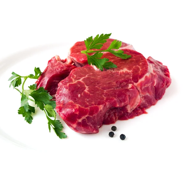 Beef fillet steak with sprig of parsley on white background, isolated — Stock Photo, Image