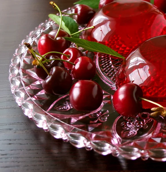 Летний освежающий десерт - красные ягоды желе с вишней на темном фоне, избирательный фокус — стоковое фото