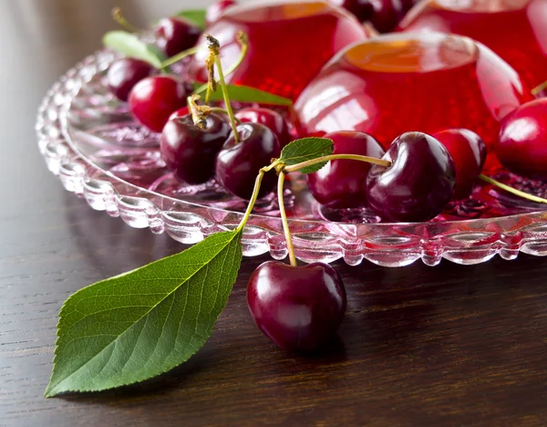 Summer refreshing dessert - red berries jelly with cherries on a dark background, selective focus — Stock Photo, Image
