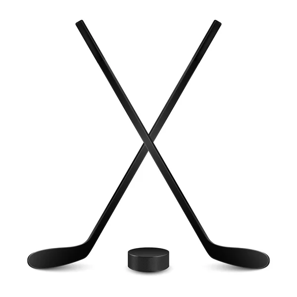 Two crossed hockey sticks and puck. Isolated on white — Stock Vector