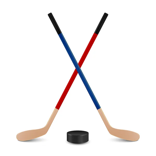 Two crossed hockey sticks and puck. 