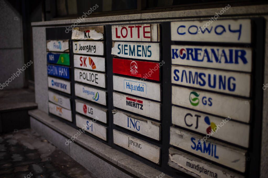 Collection of company nameplates on a wall, featuring various brands in Seoul, South Korea on 27 January 2024