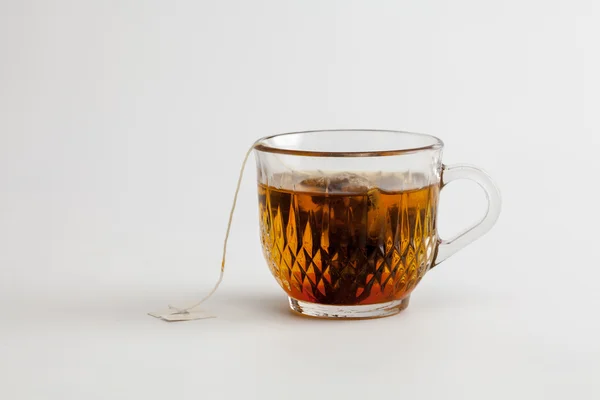 Hot tea clear glass white background — Stock Photo, Image