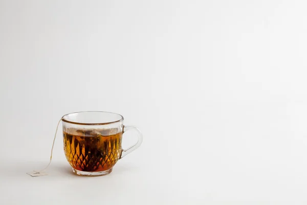 Hot tea clear glass white background — Stock Photo, Image