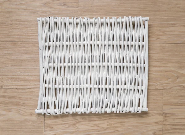 weave tray on warm wood background