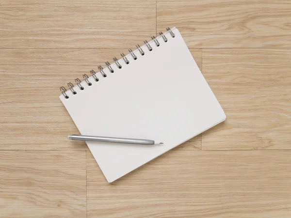 Cuaderno y lápiz sobre suelo de madera — Foto de Stock