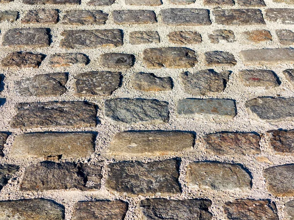 Adoquines urbanos de piedra. Textura, fondo, enfoque selectivo — Foto de Stock