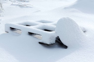 Kar yağışı, yoğun kar, kar altında inşaat paletleri.